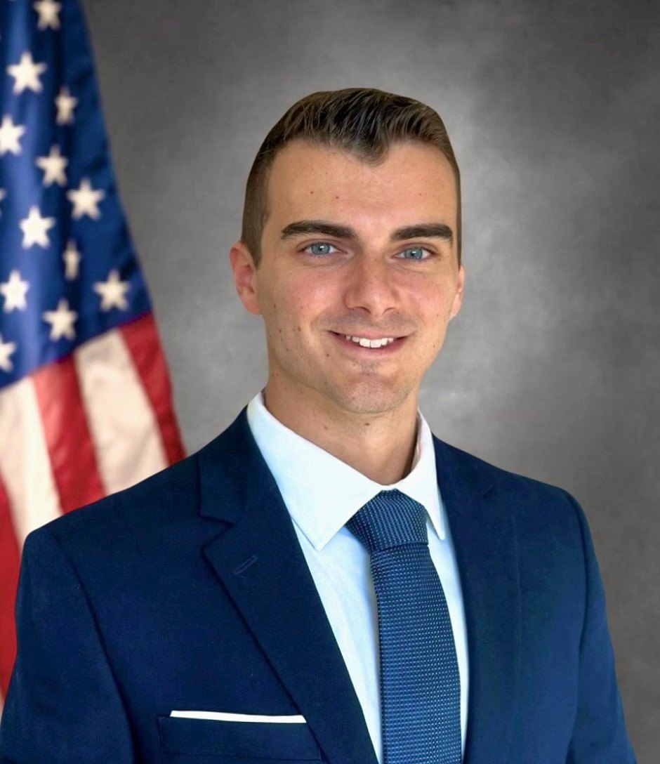 David Carrier in a navy suit and tie